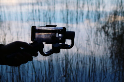 man-photographing-with-mobile-phone-water