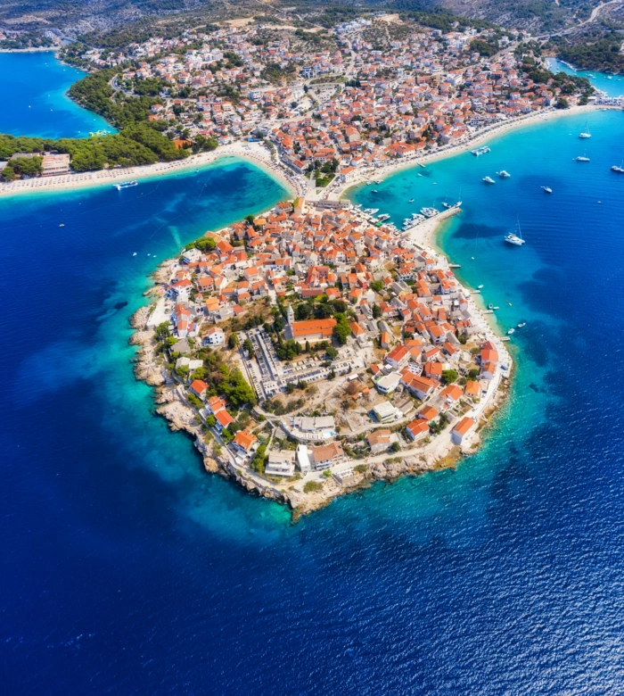 primosten-town-croatia-view-city-from-air-seascape-with-beach-old-town-view-from-drone-peninsula-with-houses-landscape-sunset-travel-image